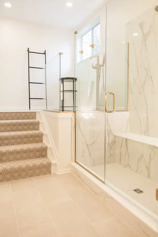 Dublin bathroom with a marble-look walk-in shower, brass fixtures and a glass door