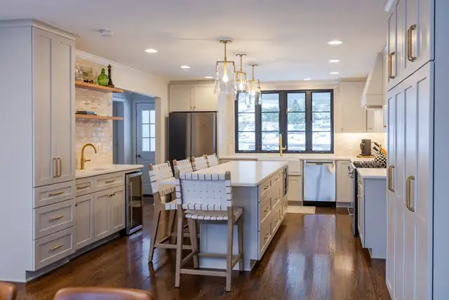 Upper Arlington, OH kitchen remodel with gray custom cabinets, white oak shelving, glass pendants and island seating